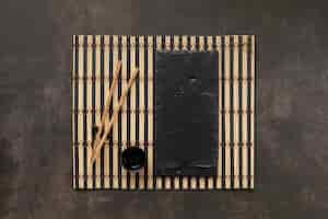 Free photo table assortment with cup and sticks flat lay