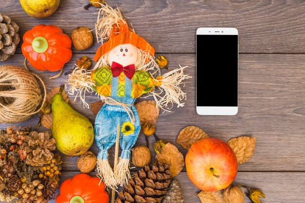 Table covered with vegetables and smartphone