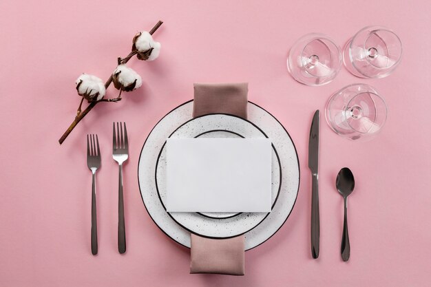 Table etiquette with pink background flat lay