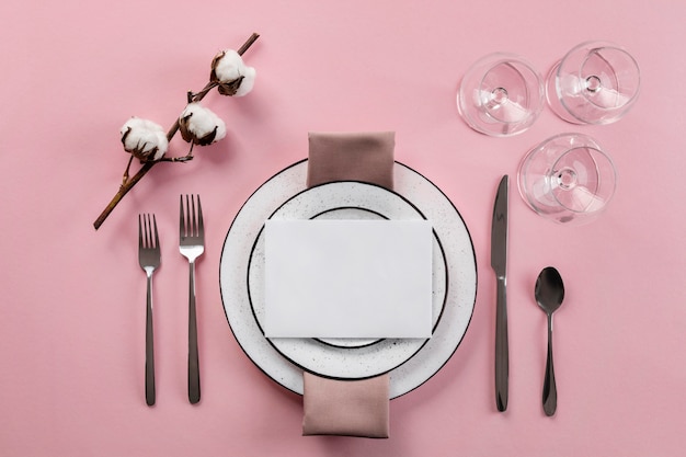 table etiquette with pink background flat lay