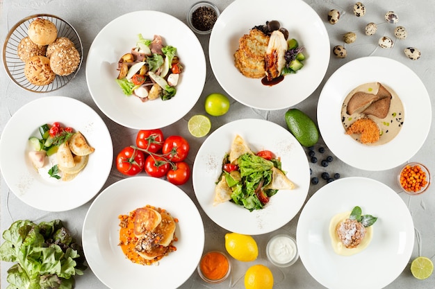 Table full of food top view on concrete table. set of dishes on the table. meat salad and dessert on table top view.