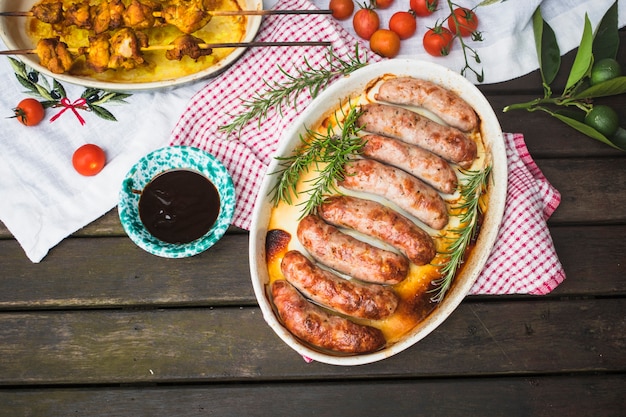 Table served with grilled meat and sausages