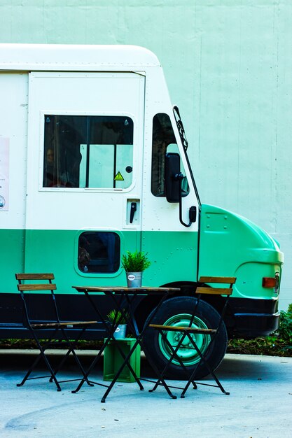 Table with chairs next to a food truck