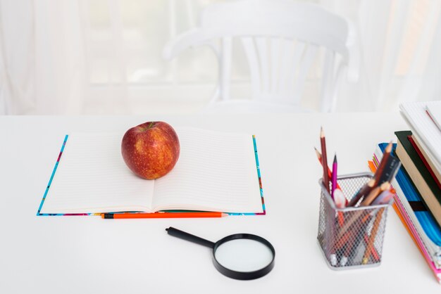 Table with copybook and pencils