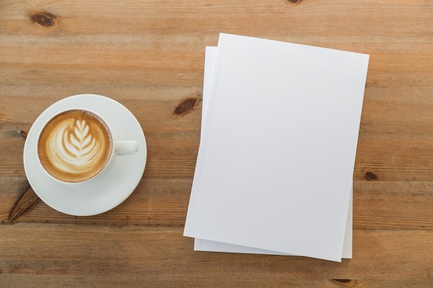 Table with cup of coffee and pieces of paper