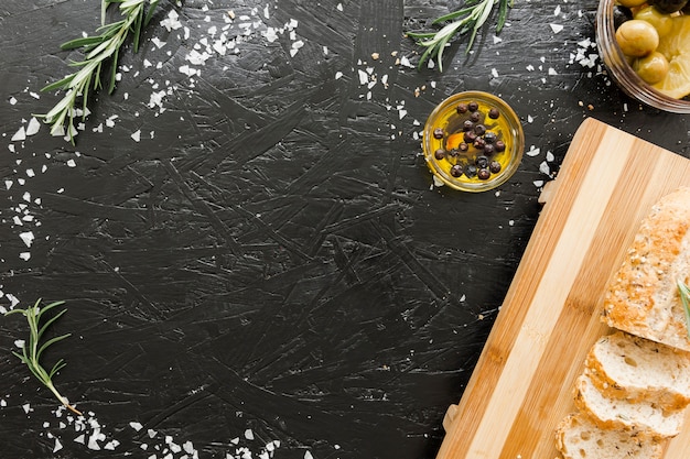 Free photo table with cutting board and bread with oil