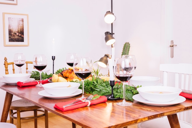 Table with dishes and red wine