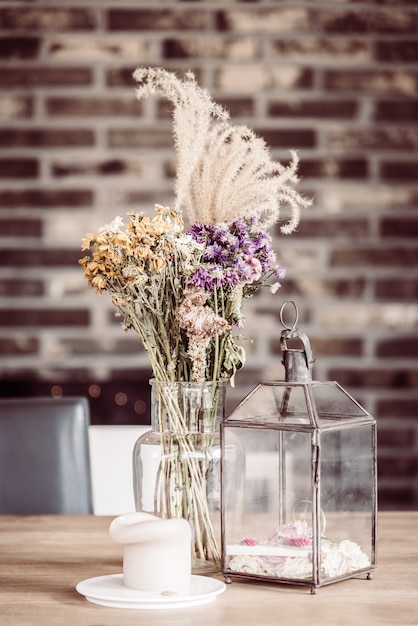 Table with a glass vase and candles