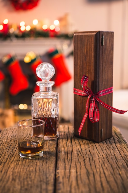 Table with liquor bottle and wooden box