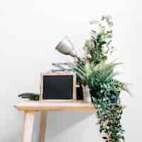 Free photo table with slate, lamp and plants