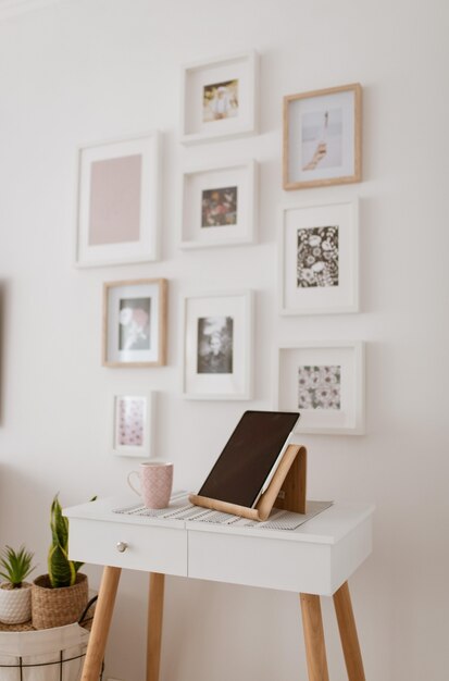 Table with a tablet on it and with the background of decorated wall