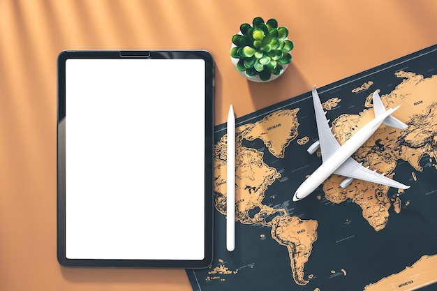 Tablet airplane miniature and world map flat lay