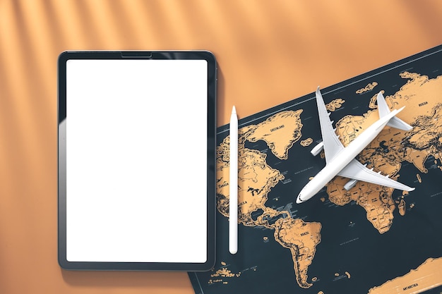 Tablet airplane miniature and world map flat lay