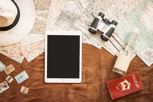 Tablet and binoculars on table