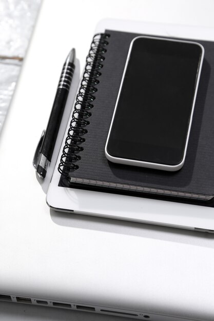 Tablet, computer,smartphone, notepad and pen on the table