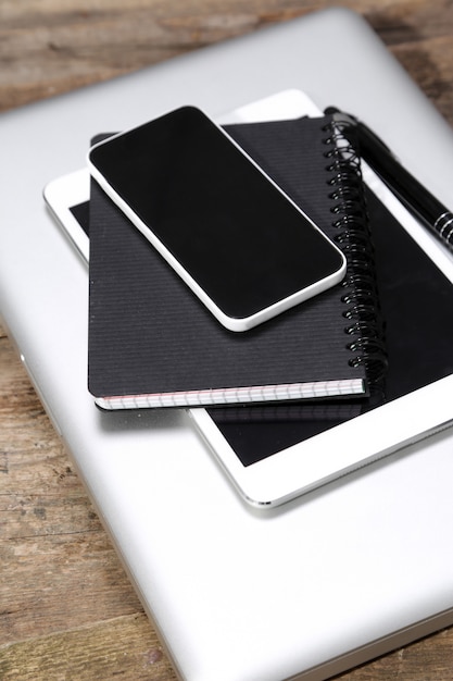 Tablet, computer,smartphone, notepad and pen on the table