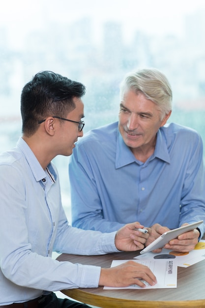 tablet consulting businessman asian coworker