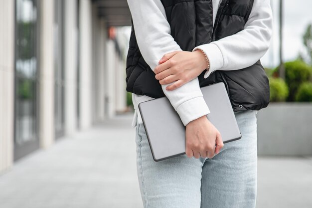 Tablet in the hands of a woman on a blurred background part of the body