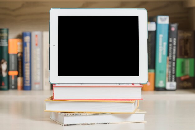 Tablet on heap of books