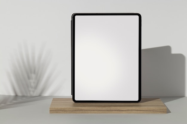 Tablet minimal display on wooden board