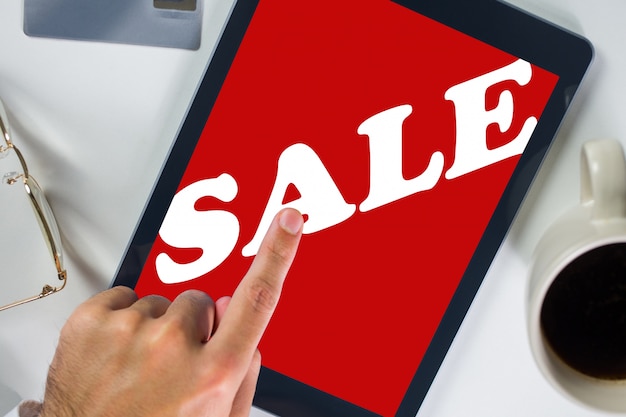 Tablet that says "sale" in white