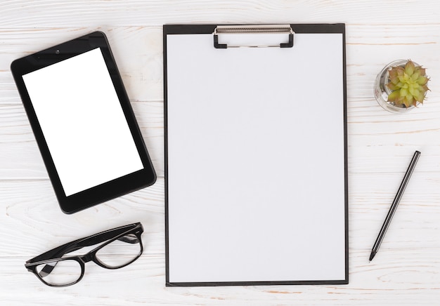 Tablet with blank clipboard on table