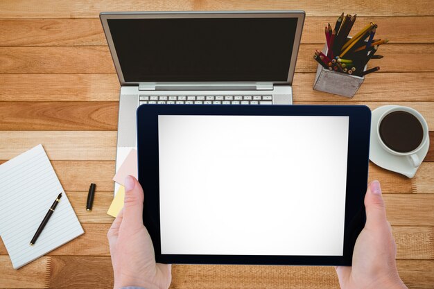 Tablet with computer and coffee cup background