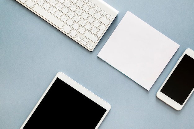 Tablet with keyboard and smartphone on table