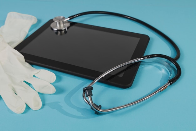 Tablet with stethoscope and latex gloves