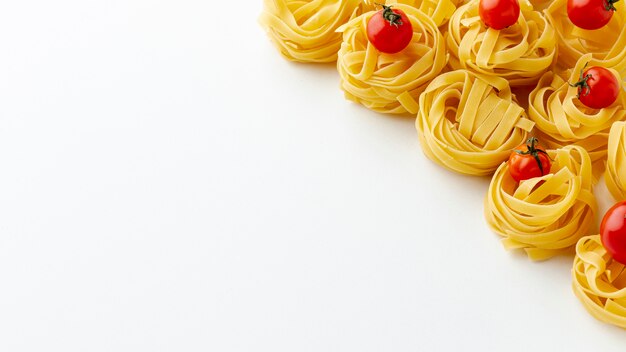 Tagliatelle and cherry tomatoes with copy space