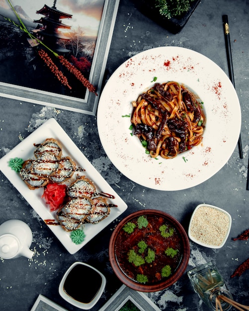 Tagliatelle with fried meat on the table