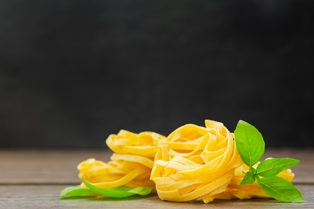 Tagliatelle on wooden surface