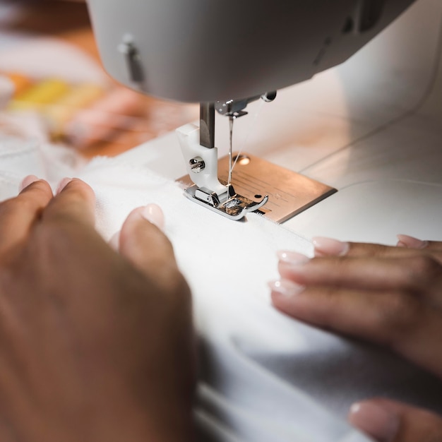 Tailor using a sewing machine close-up