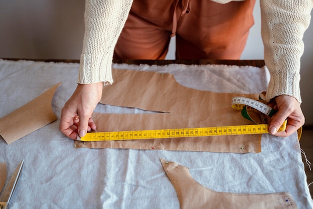 Female hands using wooden tailor ruler to measure cotton fabric. Textile  sale and sewing concept Stock Photo - Alamy