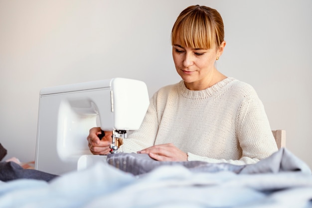 Tailor woman using sewing machine