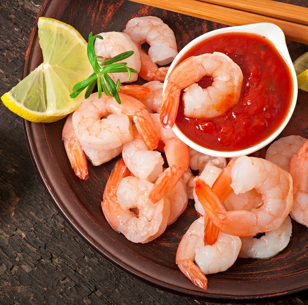 tails of shrimps with fresh lemon and rosemary in plate 