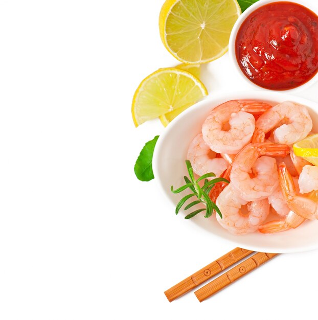 tails of shrimps with fresh lemon and rosemary in a white bowl