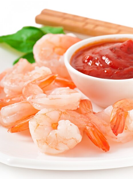 tails of shrimps with fresh lemon and rosemary in a white bowl