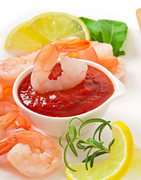 Tails of shrimps with fresh lemon and rosemary in a white bowl