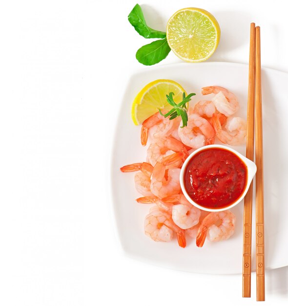 tails of shrimps with fresh lemon and rosemary in a white bowl