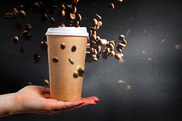 takeaway cup with coffee and coffee beans.