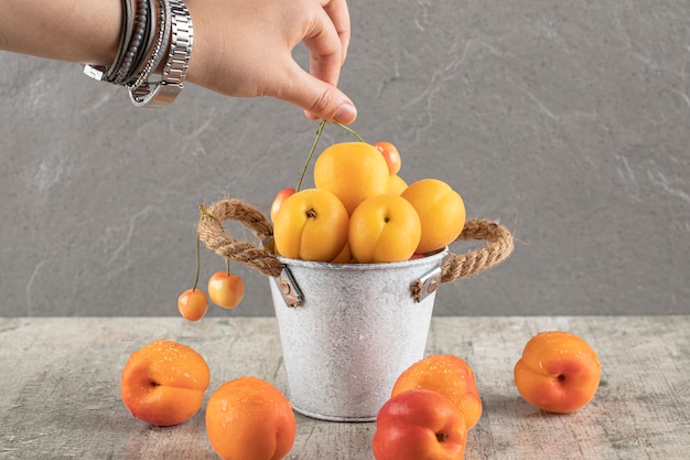 Taking an apricot from metallic tile