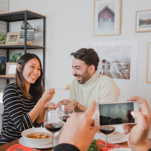 Taking photo of couple at christmas dinner