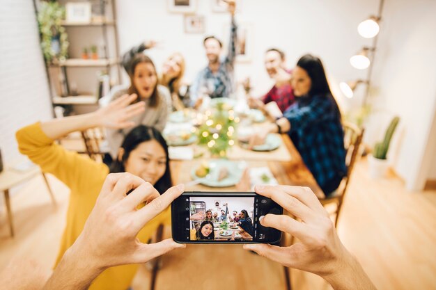 テーブルに座っている友達の写真を撮る