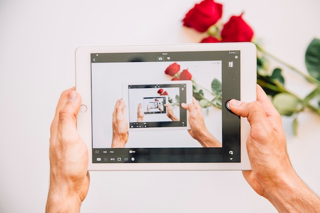 Taking photo of roses with tablet