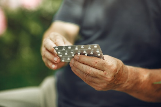 Taking pills. Close up of a white pills in man's hands.