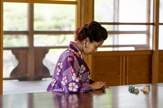 Talented woman making origami with japanese paper