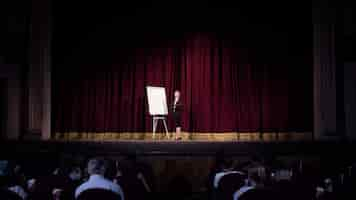 Free photo talking to students. female speaker giving presentation in hall at workshop. business centre. rear view of participants in audience. conference event, training.