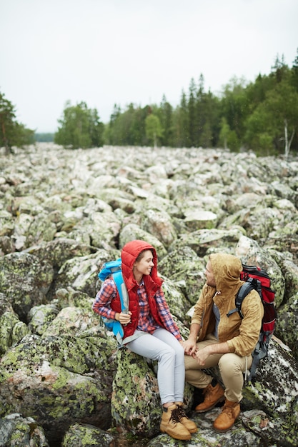 Free photo talking travelers on rocks