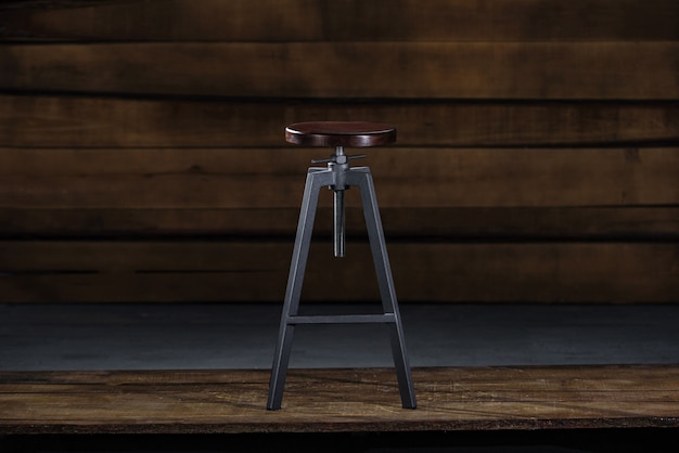 Tall bar stool on a wooden background